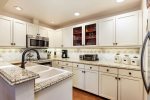 Upgraded kitchen with granite countertops and stainless steel appliances